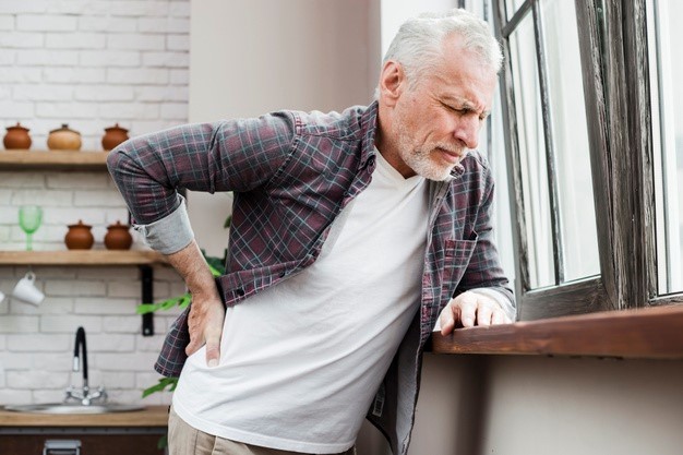 senior citizen experiencing joint pain at home