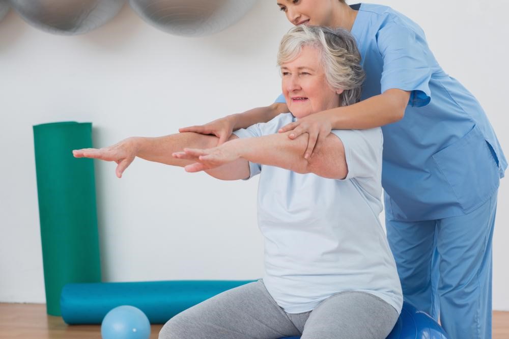 physical therapist guiding a senior citizen