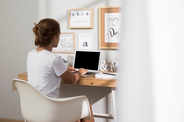 woman experiencing lower back pain when working from home