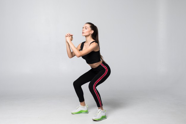 patient with knee pain performing half squats to alleviate pain