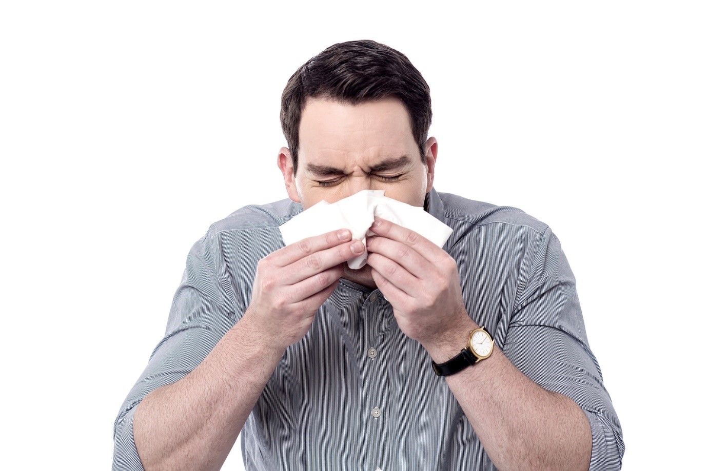 A man blowing his nose into a paper napkin.