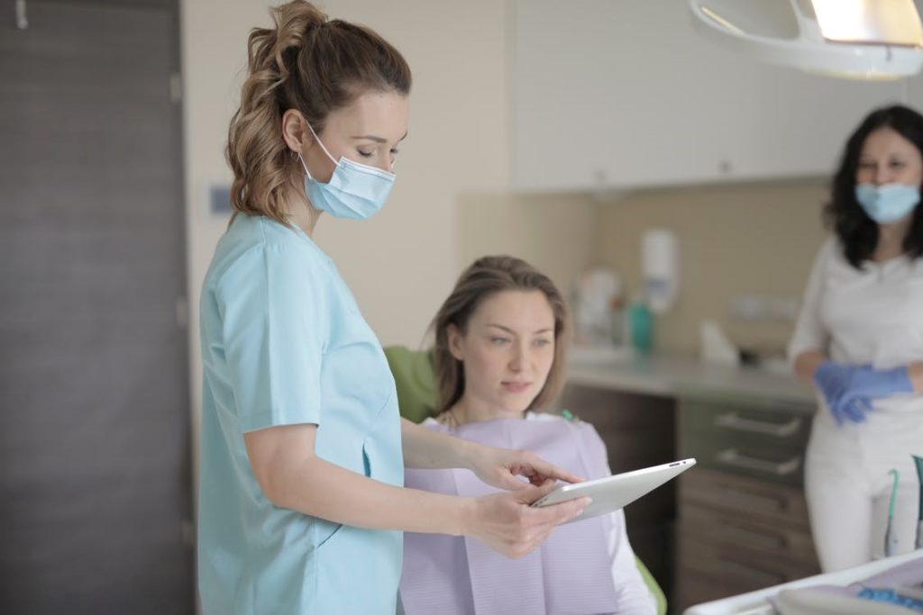 Doctor talking with female patient about the pelvic exam