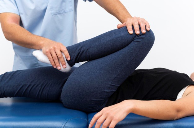 A man getting physiotherapy for knee pain