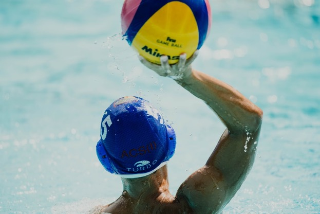 man throwing ball in water polo