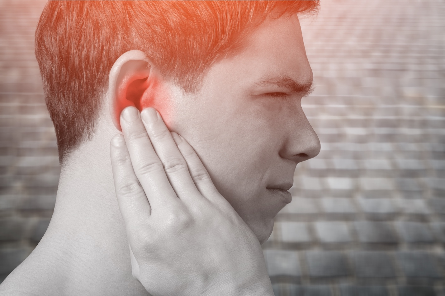 A man suffering from ear ache.