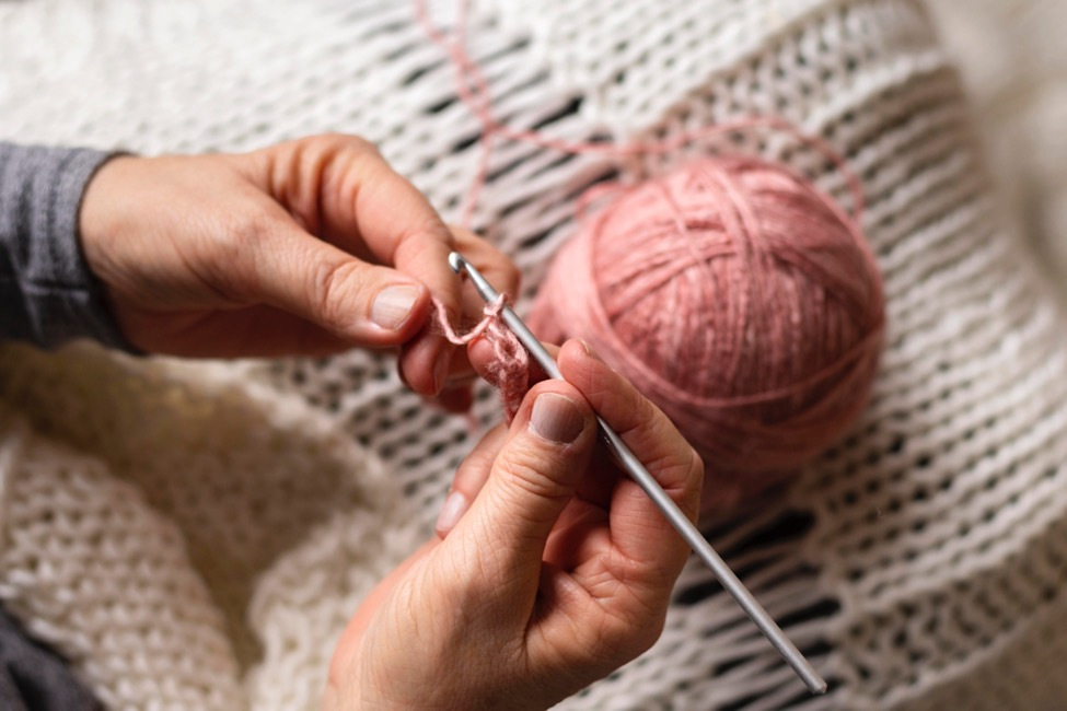 Hands working with a crochet hook