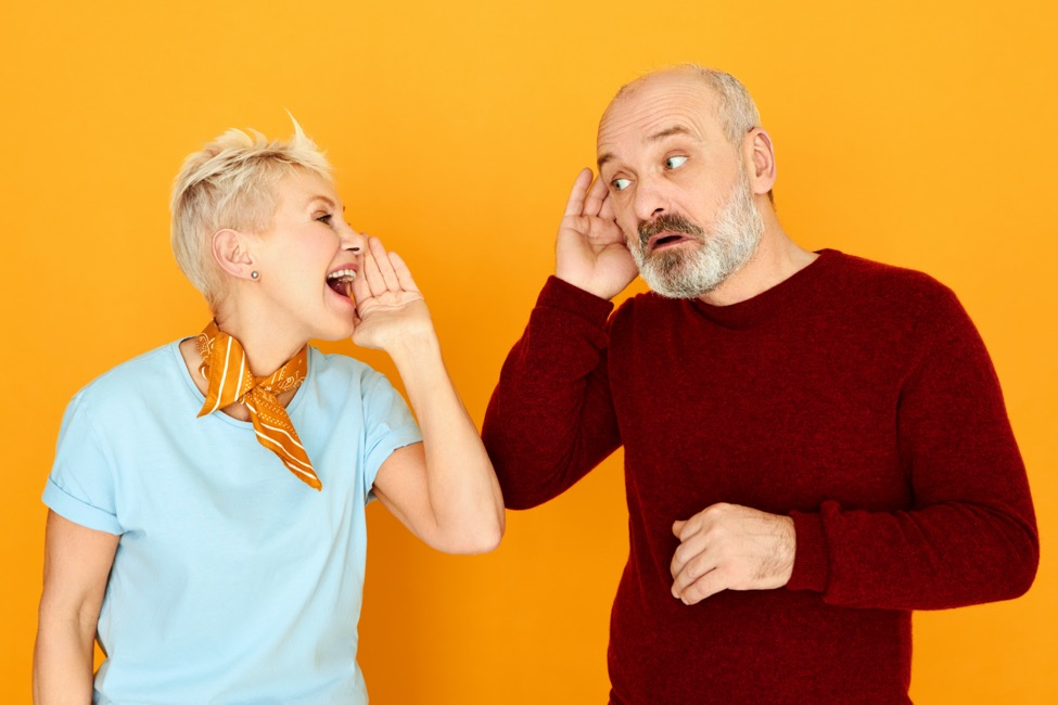 A woman yells at a man who has lost his hearing