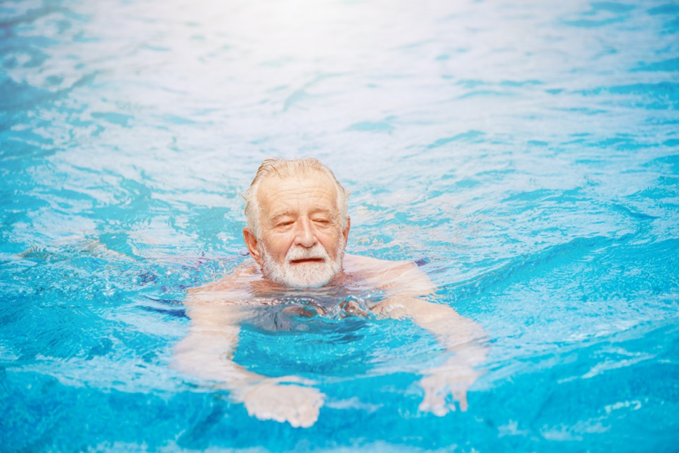 a man with a beard swimming in a pool to prevent heart disease