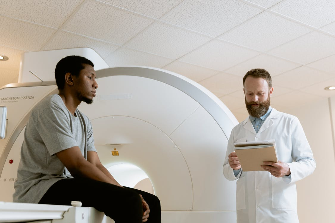 an MRI technologist setting up a 3T MRI scan for a patient