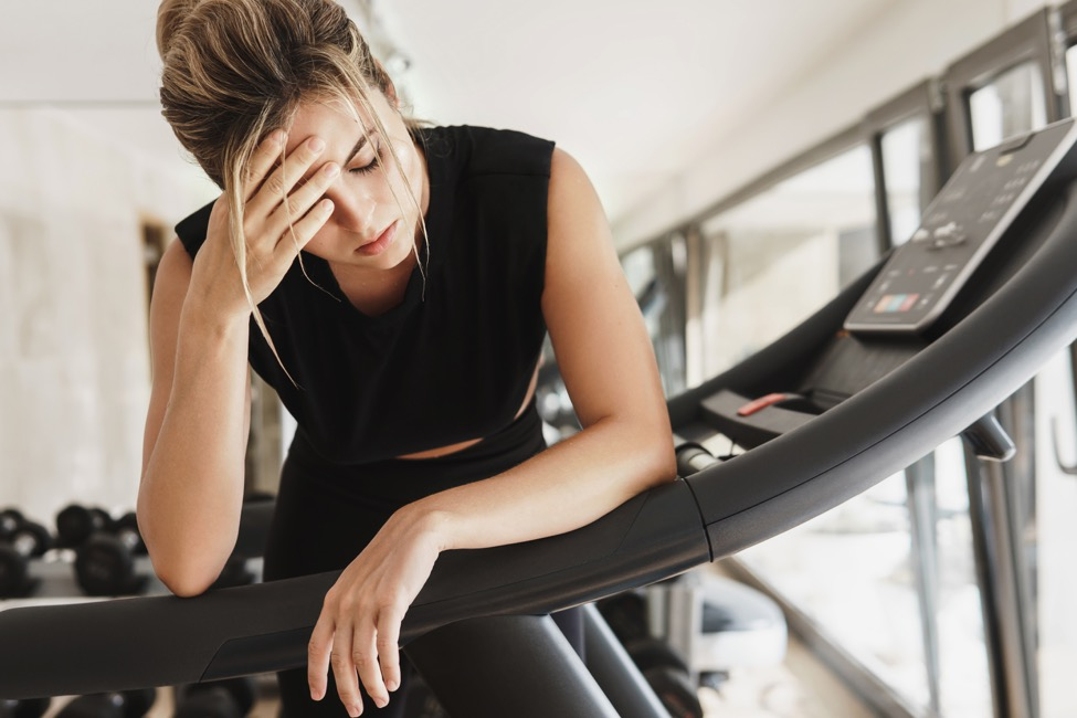 a woman with vertigo at the gym