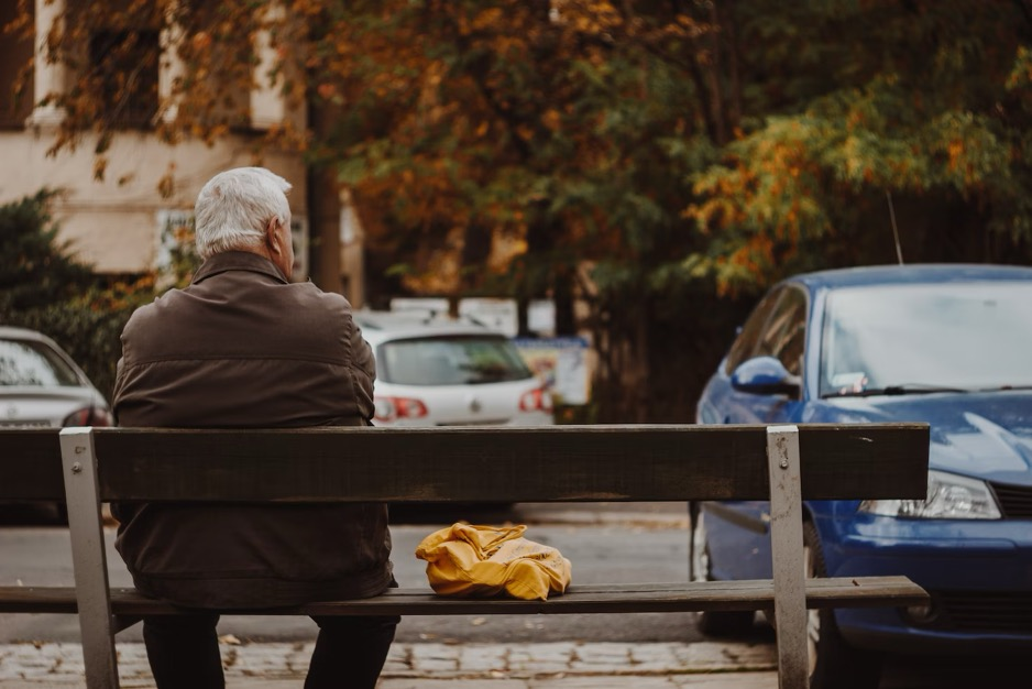 an older man sitting on a bench