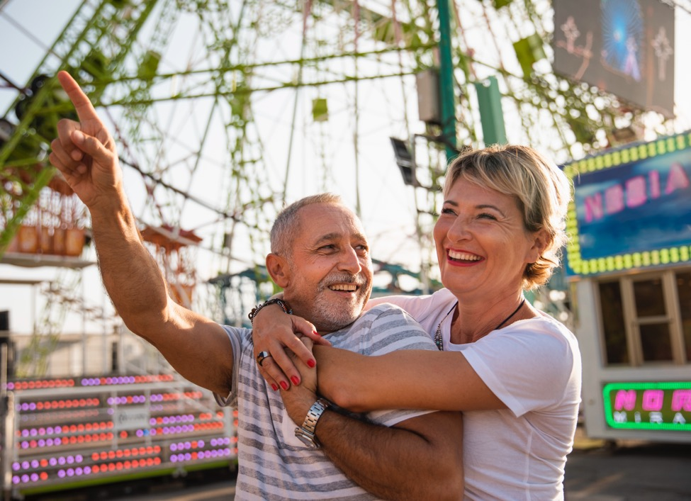 Couple smiling and enjoying time at the amusement park