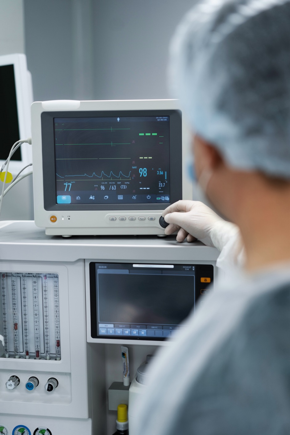 A cardiologist presses a button on a pulse monitor.