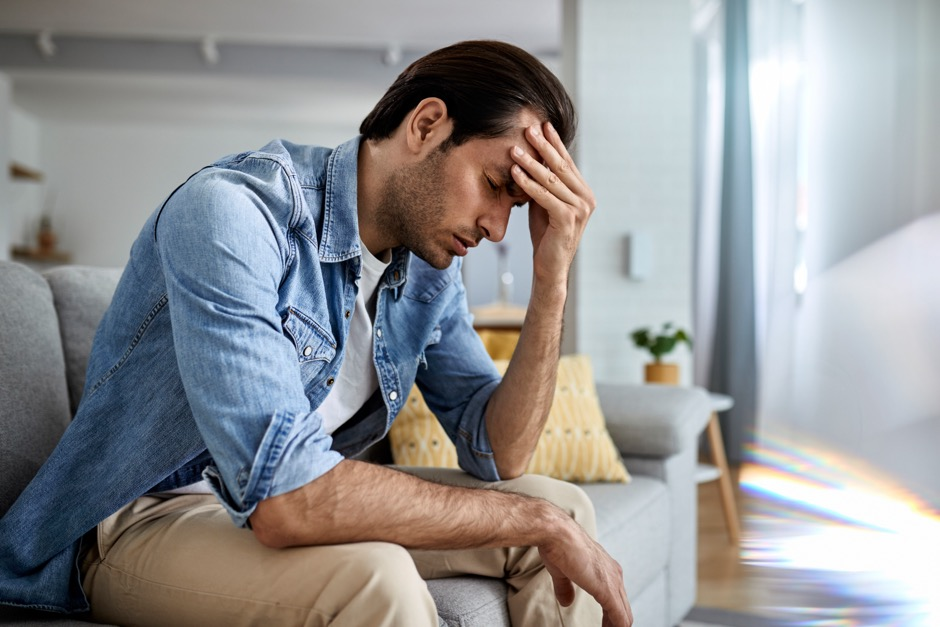 a young man with a severe headache