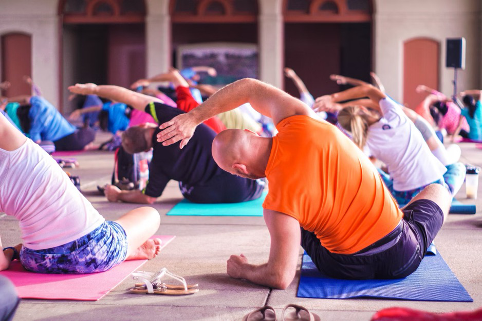 A group of people stretching on yoga mats