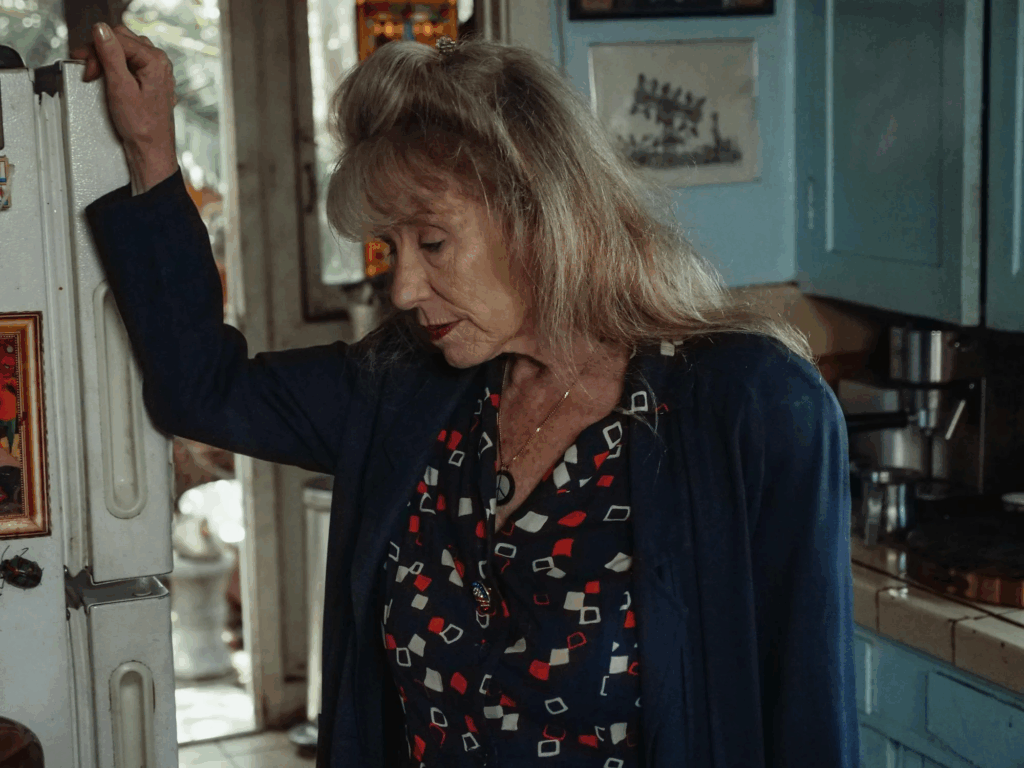 An elderly woman appearing tired.