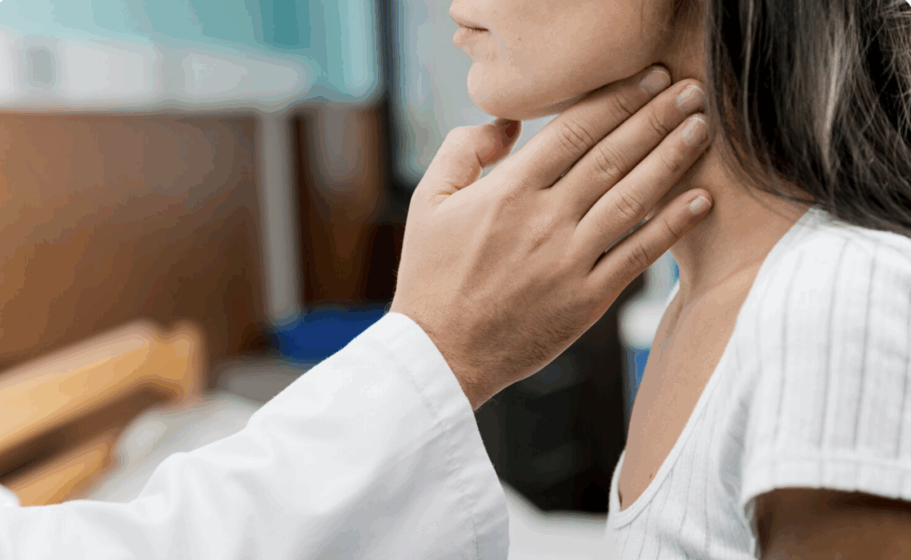 A doctor preparing a patient for a throat examination in a medical office.