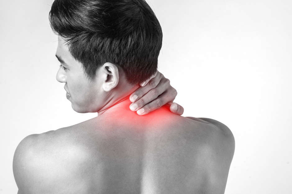 A man with his hand on the back of his neck.